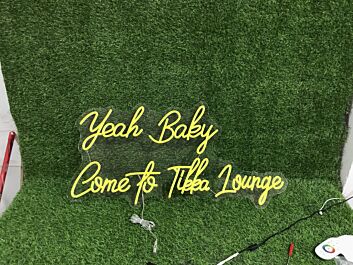 Brighten Up Your Bar, Restaurant, or Home Party Ambiance with the Yeah Baby Come To Tikka Lounge Yellow LED Neon Sign.