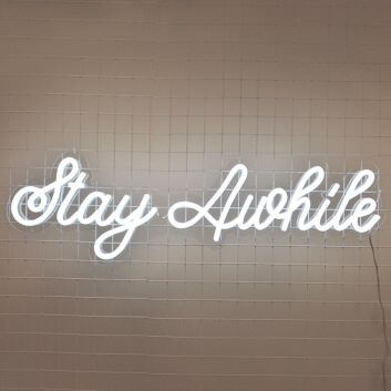 Stay Awhile Neon Sign perfect for cozy living room settings