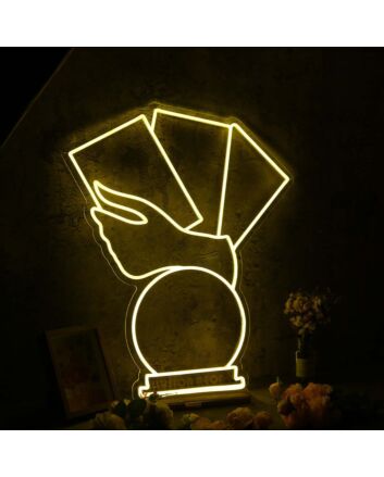 A Hand Holding Books Yellow Neon Sign
